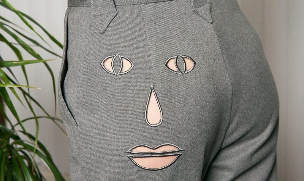 Shoppers stunned by £129 trousers with a cheeky face cut-out for “fart ventilation” as viral Fashion Brand Company design sparks laughs with its quirky office-ready twist.