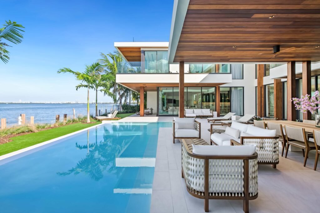 F1 star Eddie Irvine lists his £27.6m Miami waterfront mansion with 6 bedrooms, rooftop terrace, theatre, pool and 360° views of Biscayne Bay and the city skyline.